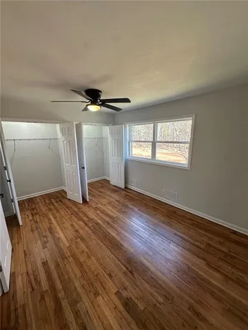 a view of a livingroom with wooden floor and window