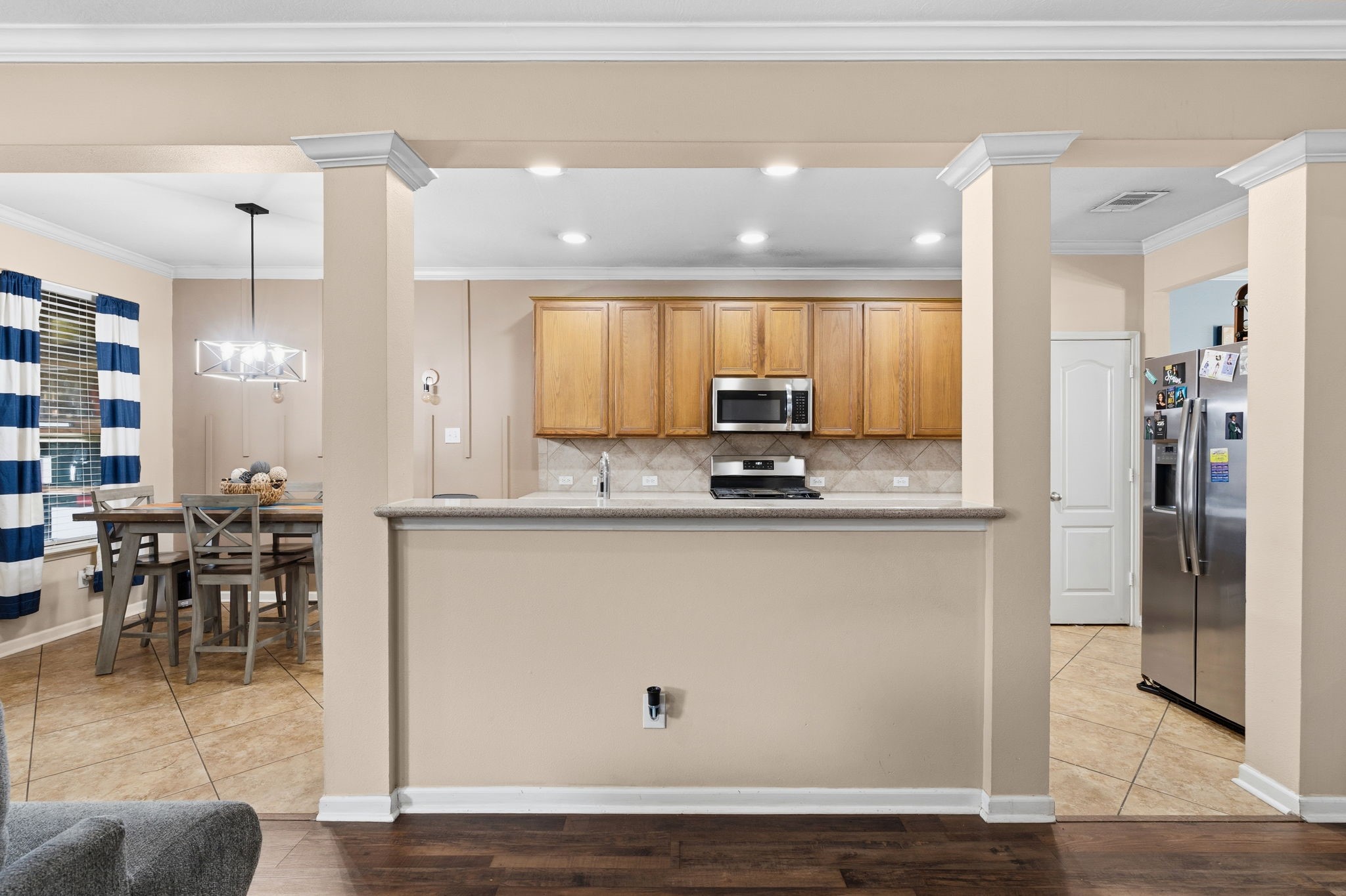 1319 Collier Point Lane Fresno, TX 77545 - Photo 10 of 33 An open-concept kitchen features a spacious breakfast bar that effortlessly connects to the living areas, allowing for seamless entertaining and comfortable everyday living.