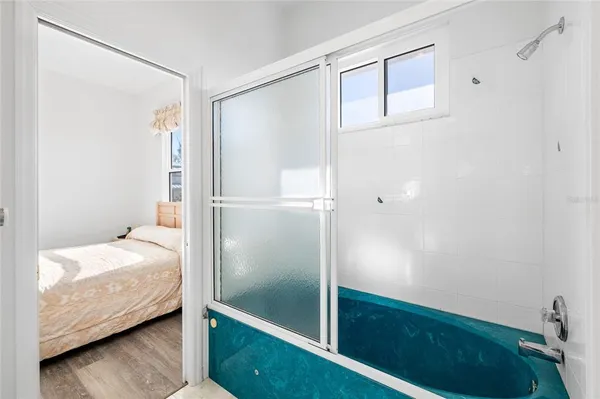 a bedroom with a bed a desk and chair