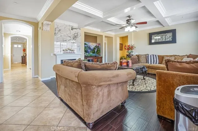 a living room with furniture kitchen view and a fireplace