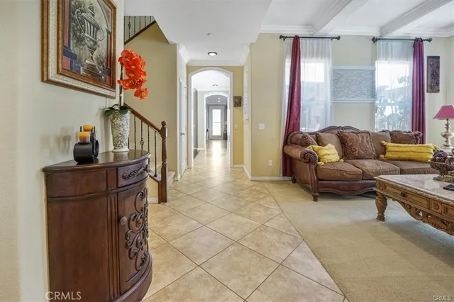 a living room with furniture a window and a wooden floor