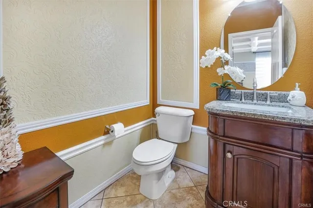 a dining room with furniture a chandelier and wooden floor