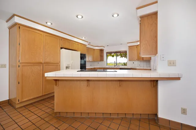 a view of a kitchen with wooden floor and a chandelier