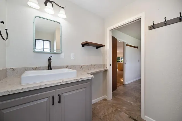 a view of a patio with table and chairs and potted plants