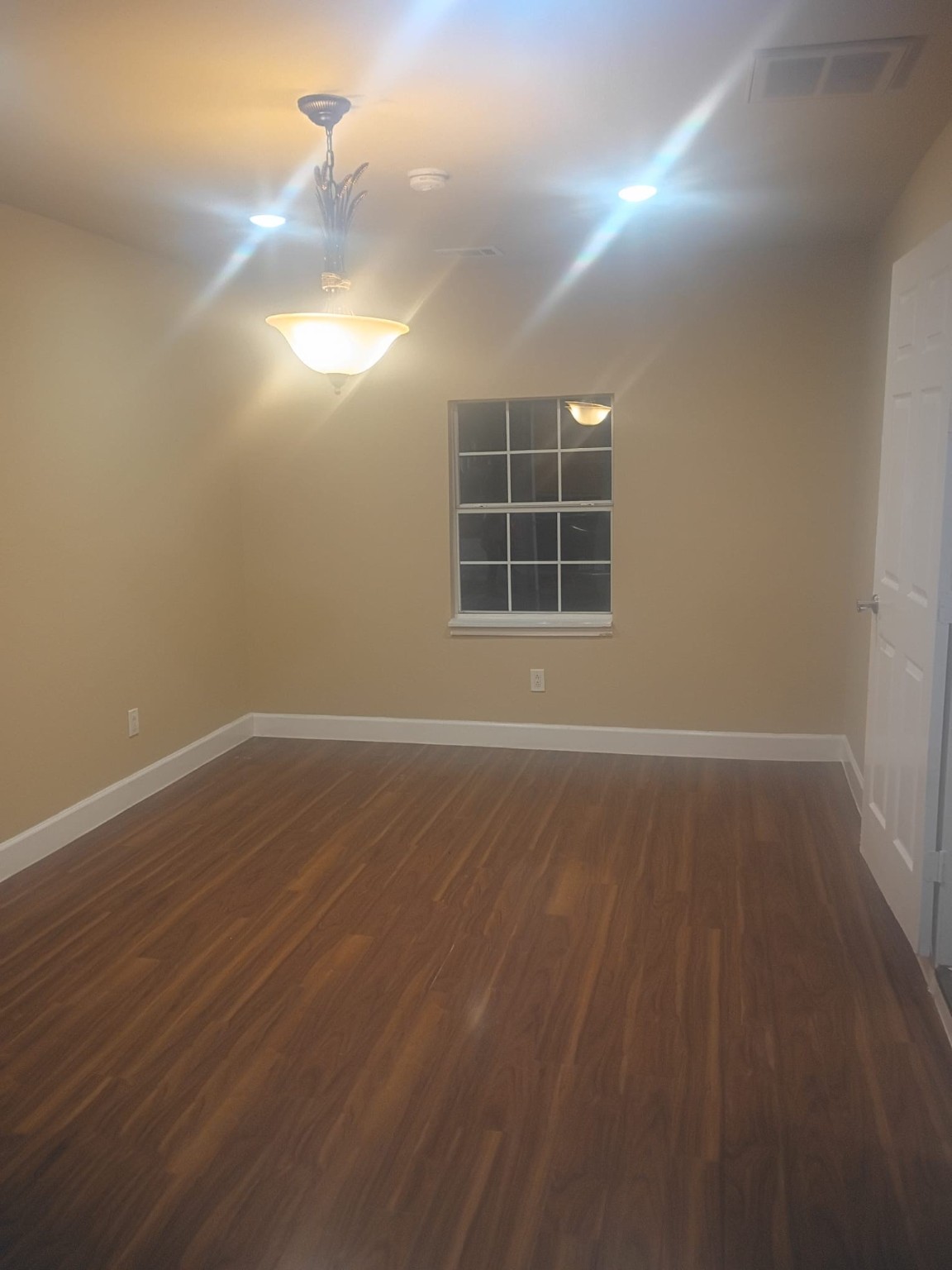 3014 Bloomfield Street Houston, TX 77051 - Photo 9 of 13 an empty room with wooden floor and windows