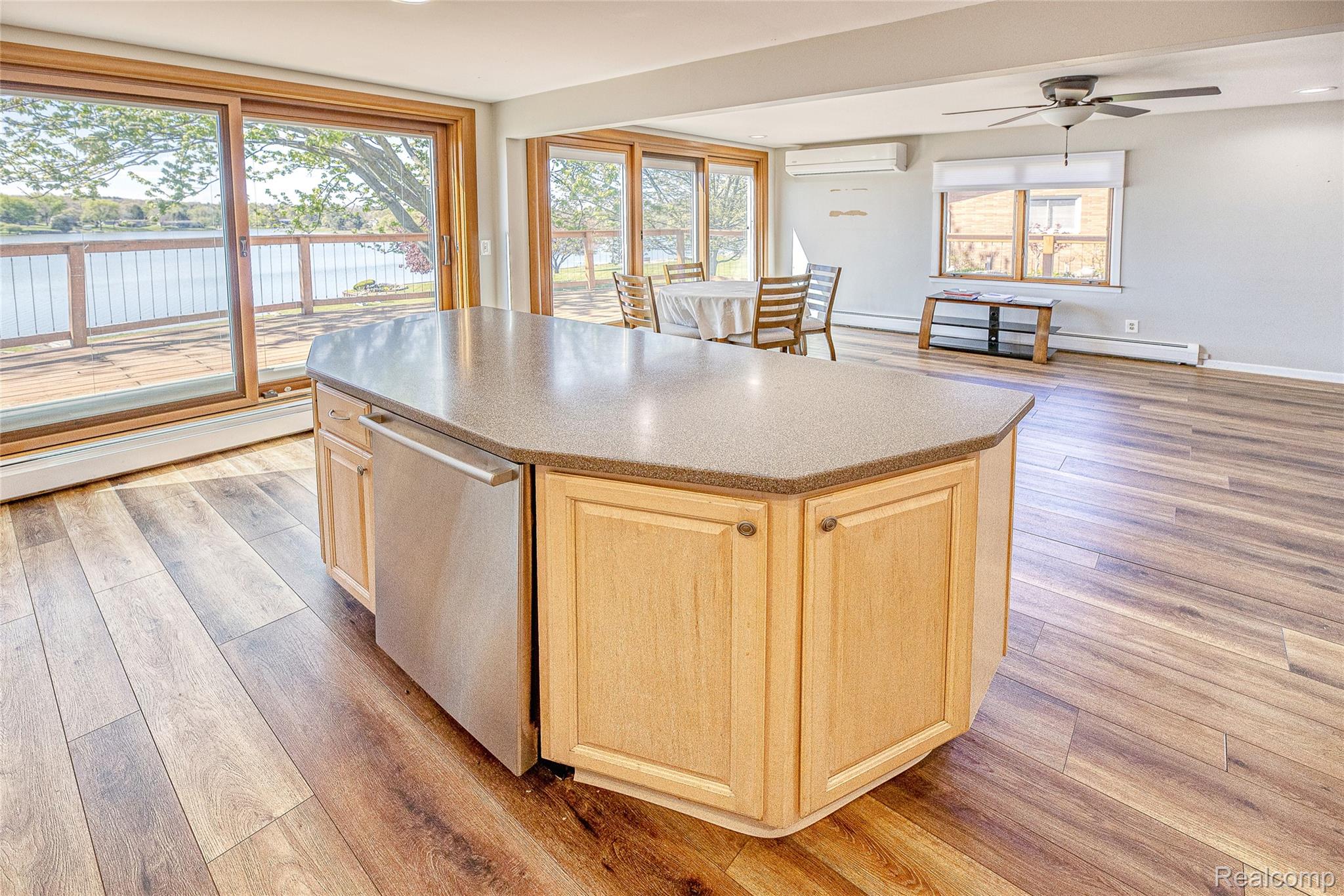 2855 Farmers Creek Road Metamora, MI 48455 - Photo 11 of 51 Kitchen island with light wood cabinetry, a solid surface countertop, and an integrated stainless steel dishwasher
