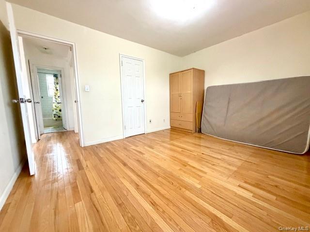 67-20 218th Street, Unit LOWR Queens, NY 11364 - Photo 12 of 17 a view of empty room with wooden floor