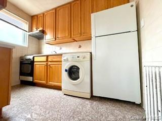 67-20 218th Street, Unit LOWR Queens, NY 11364 - Photo 4 of 17 Laundry room with washer / clothes dryer, radiator, and light flooring