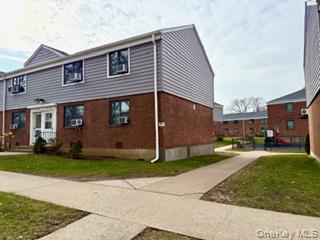 67-20 218th Street, Unit LOWR Queens, NY 11364 - Photo 5 of 17 a front view of a house with a yard