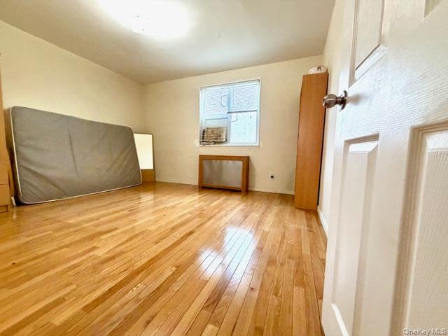 67-20 218th Street, Unit LOWR Queens, NY 11364 - Photo 6 of 17 a view of an empty room with wooden floor and a window