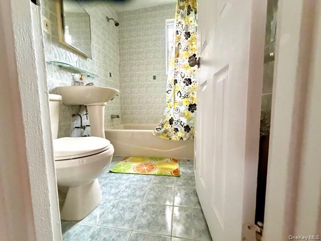 67-20 218th Street, Unit LOWR Queens, NY 11364 - Photo 9 of 17 a bathroom with a sink toilet and shower