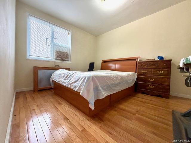 67-20 218th Street, Unit LOWR Queens, NY 11364 - Photo 10 of 17 a bedroom with a bed and a closet