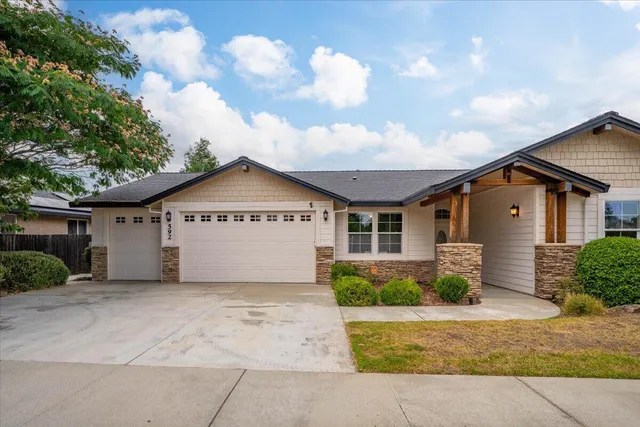 a view of house with a garden and pathway