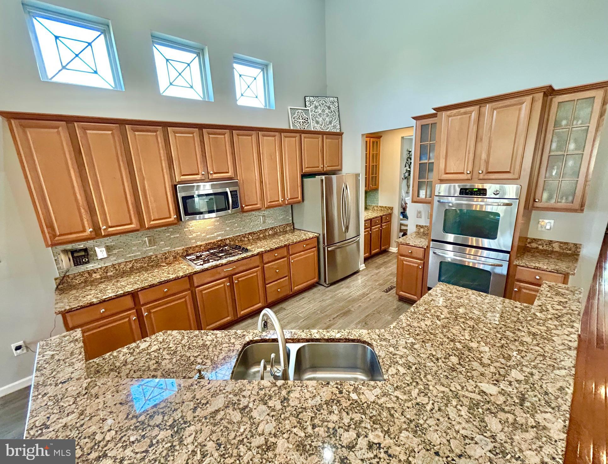 18 Applegate Drive Florence, NJ 08518 - Photo 16 of 81 a kitchen with granite countertop a stove a sink and a refrigerator