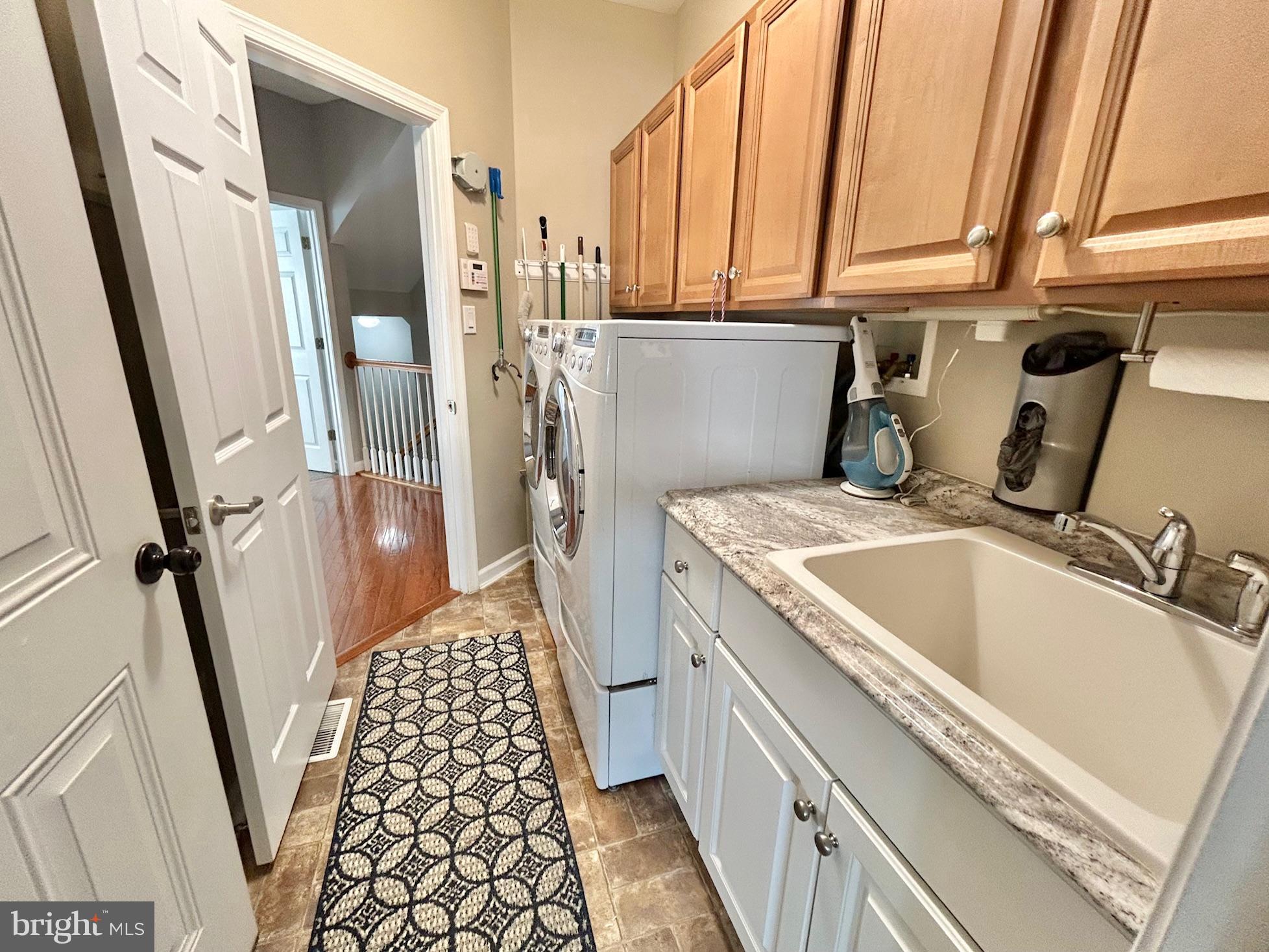 18 Applegate Drive Florence, NJ 08518 - Photo 39 of 81 a kitchen with a sink a refrigerator and washer