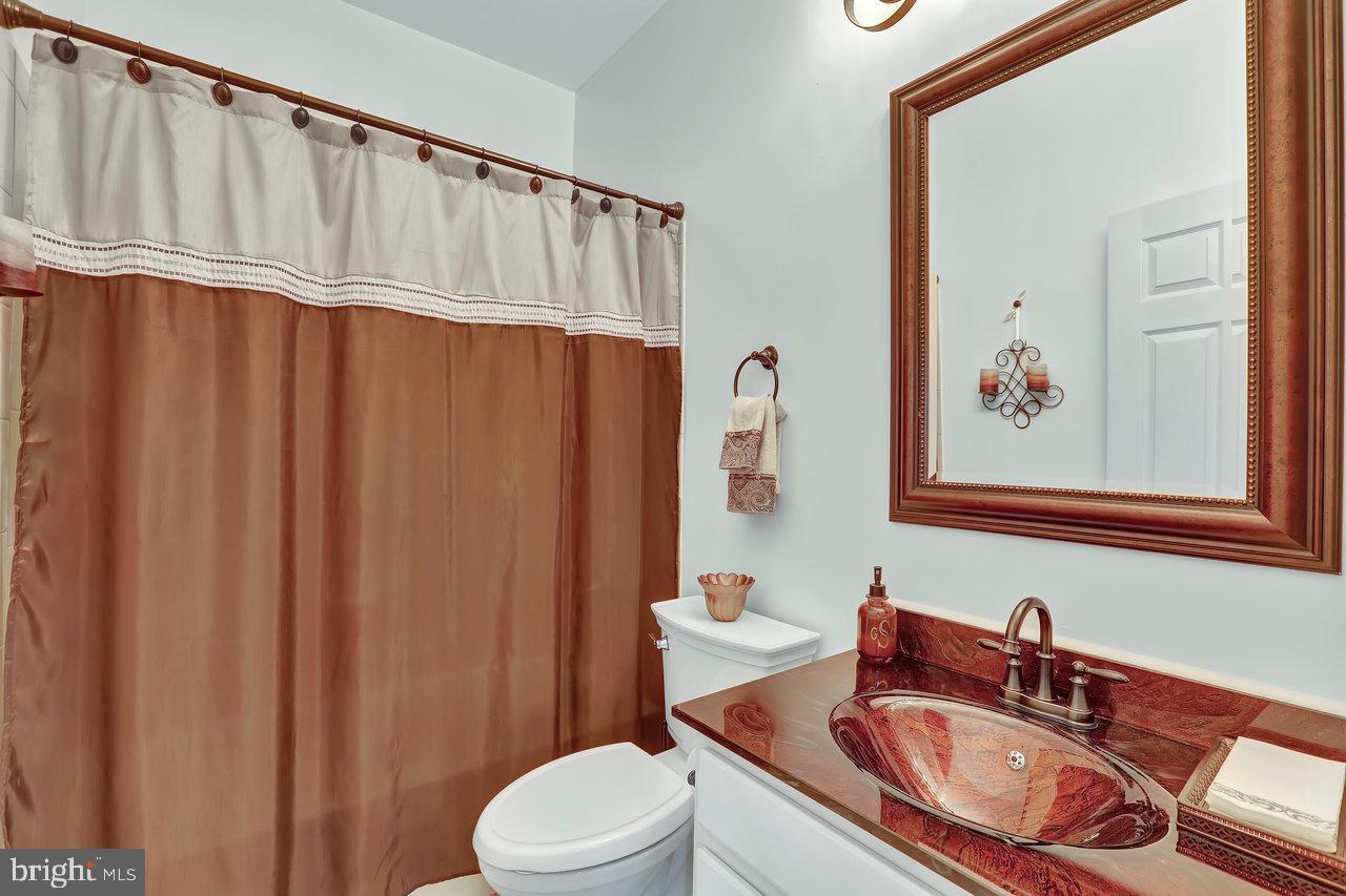 18 Applegate Drive Florence, NJ 08518 - Photo 40 of 81 a bathroom with a sink a toilet and shower curtain