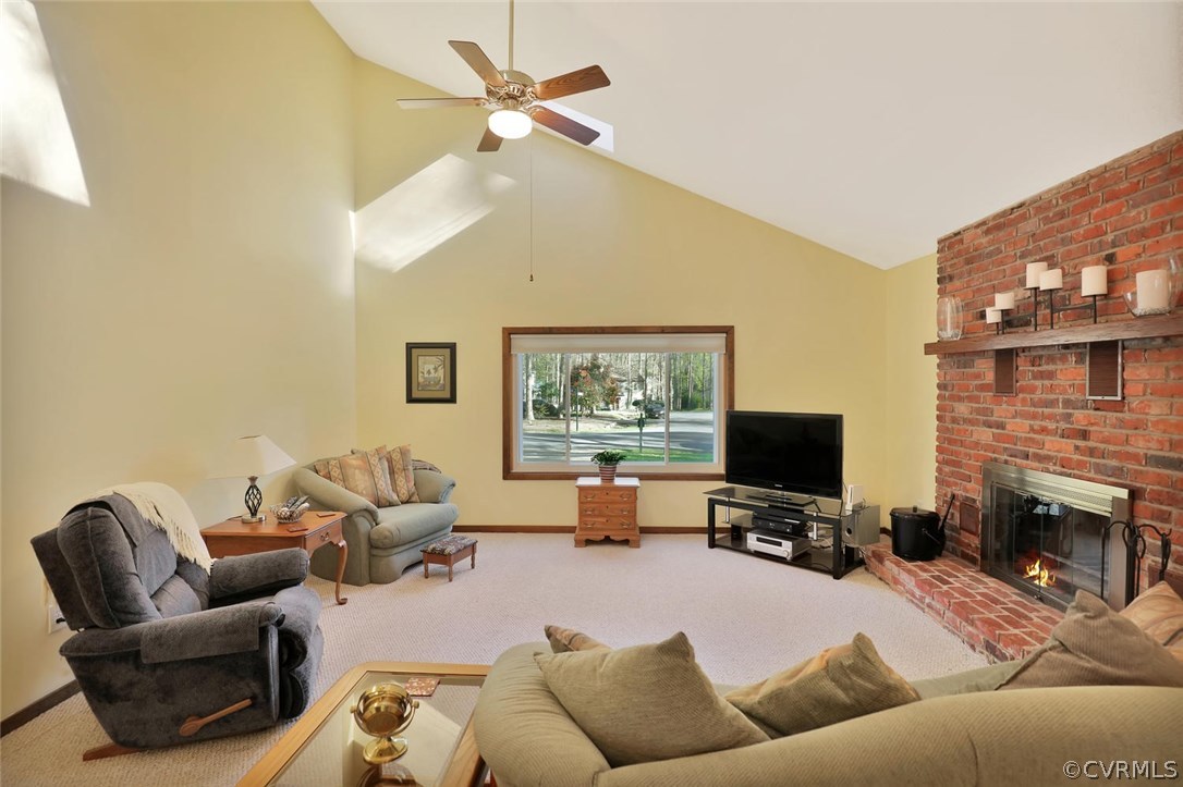 13604 Hunts Bridge Road Midlothian, VA 23112 - Photo 6 of 22 a living room with furniture a fireplace and a flat screen tv