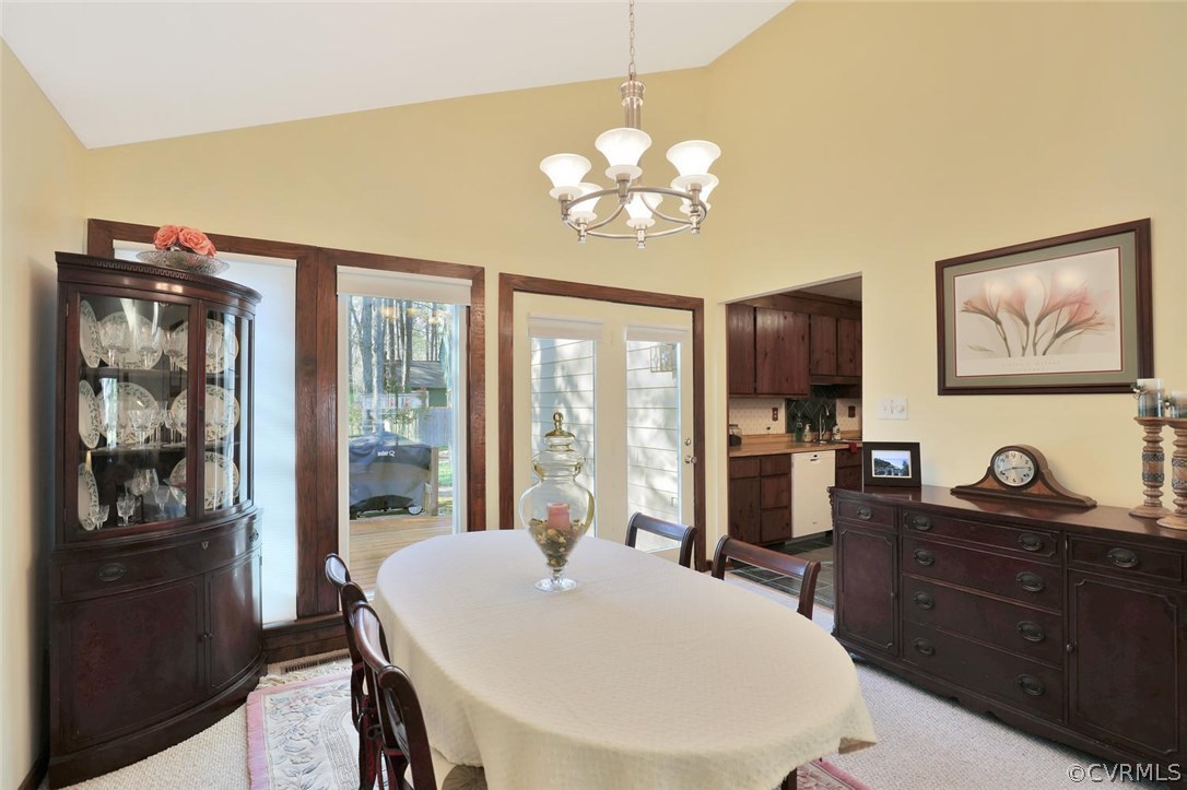 13604 Hunts Bridge Road Midlothian, VA 23112 - Photo 8 of 22 a view of a dining room with furniture large window and chandelier