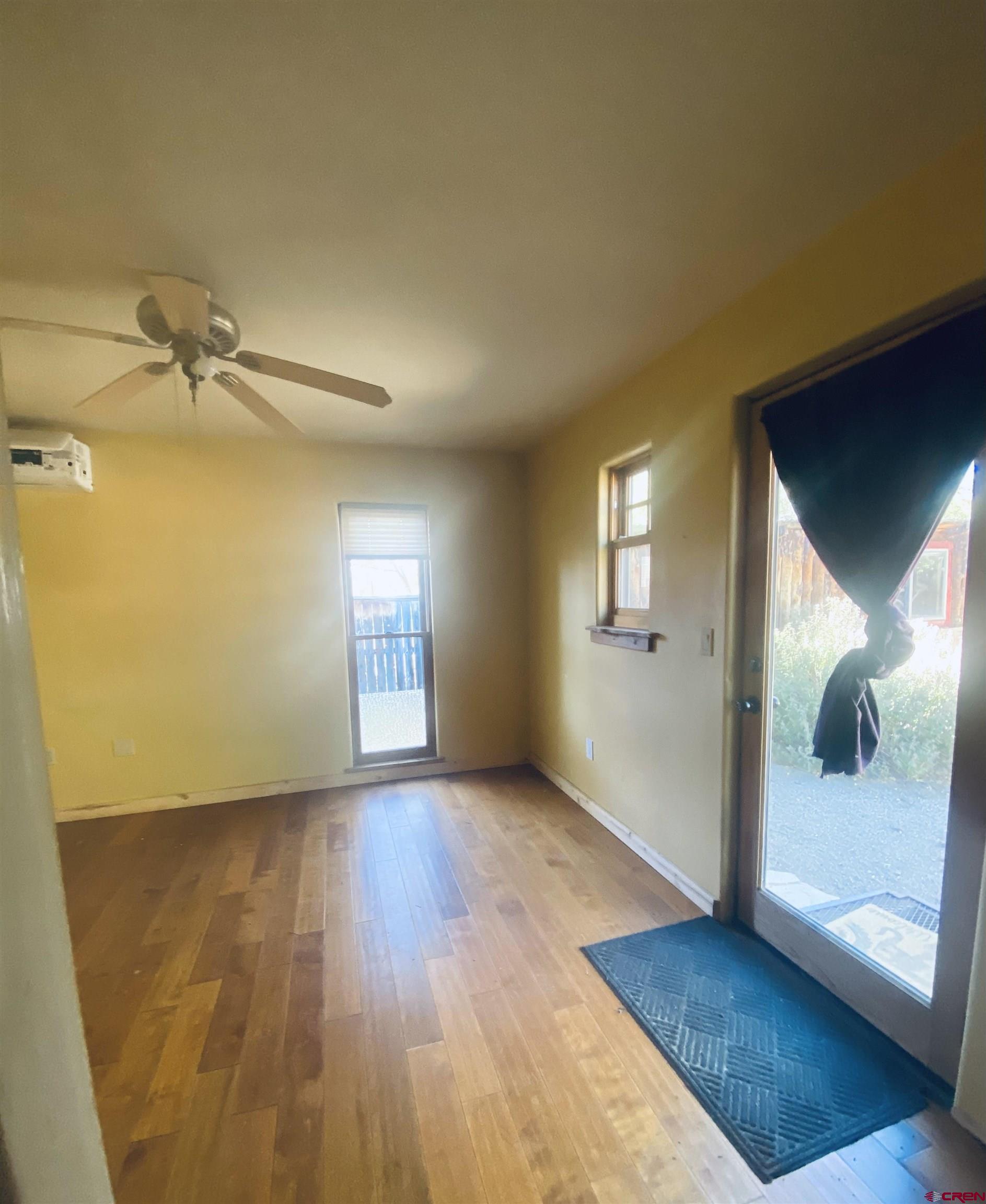 646 Riverside Avenue Mancos, CO 81328 - Photo 12 of 36 wooden floor in an empty room with a window