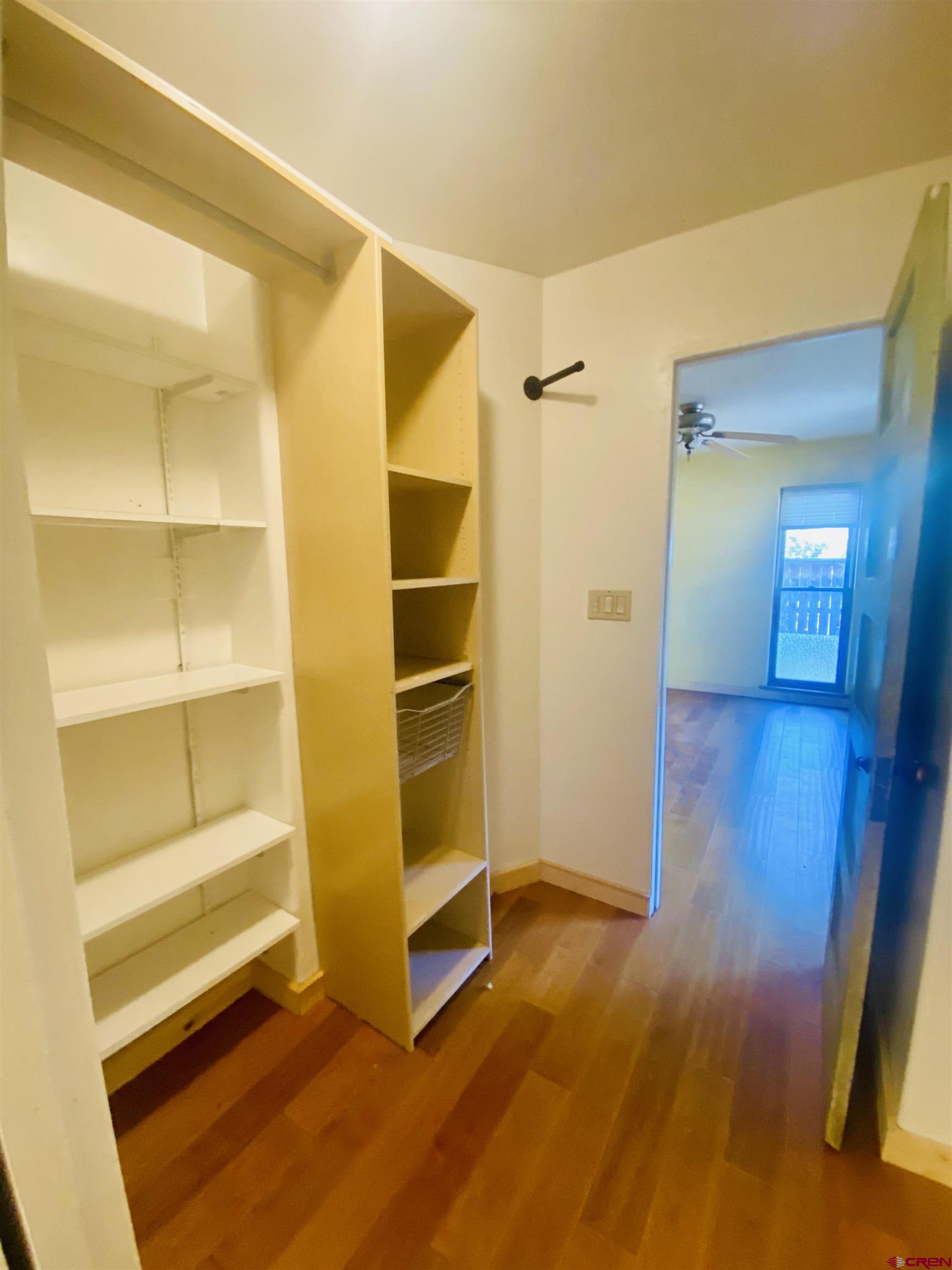 646 Riverside Avenue Mancos, CO 81328 - Photo 15 of 36 a view of an empty room with wooden floor and a window