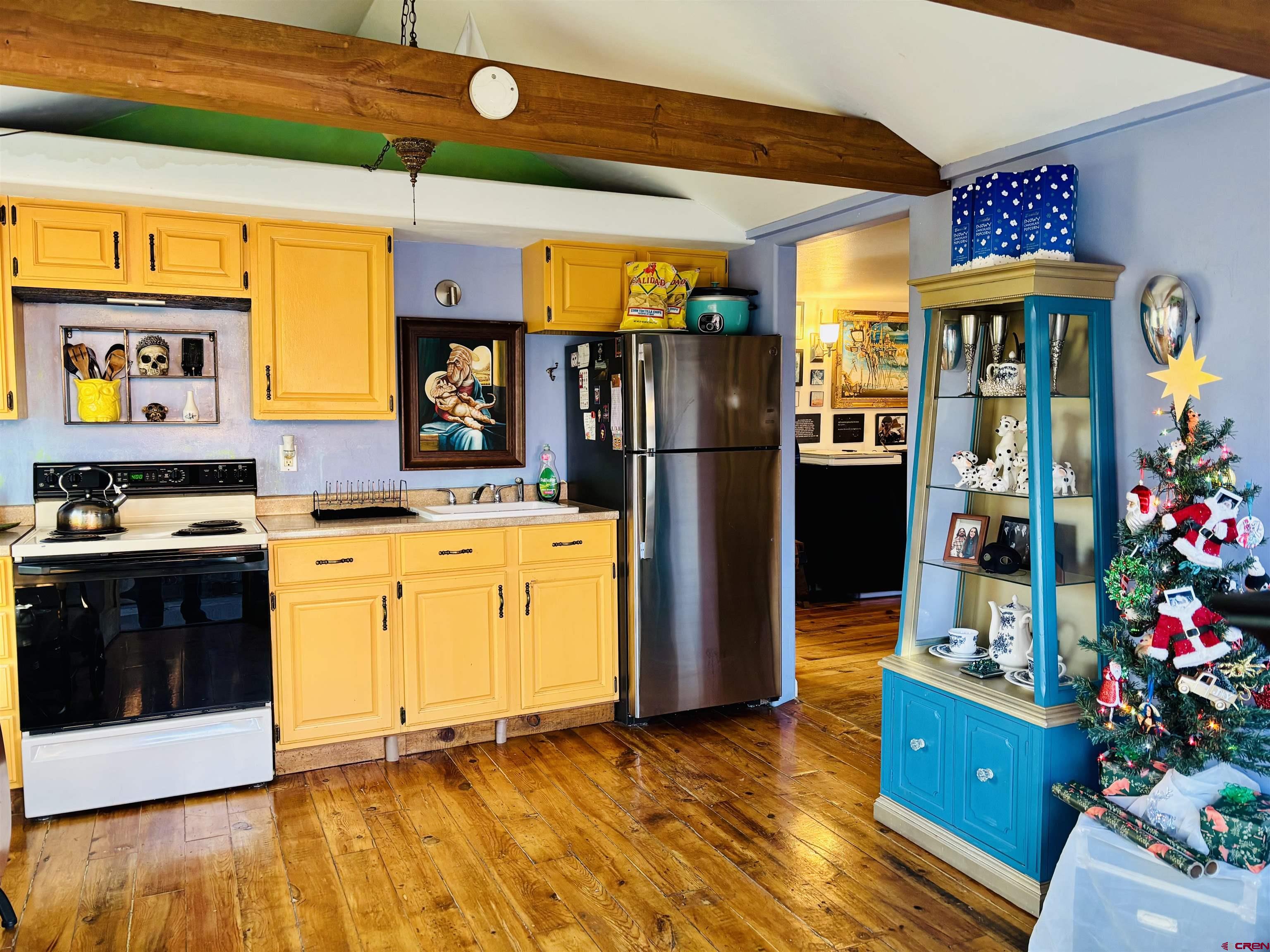 646 Riverside Avenue Mancos, CO 81328 - Photo 25 of 36 a kitchen that has a lot of cabinets and stainless steel appliances