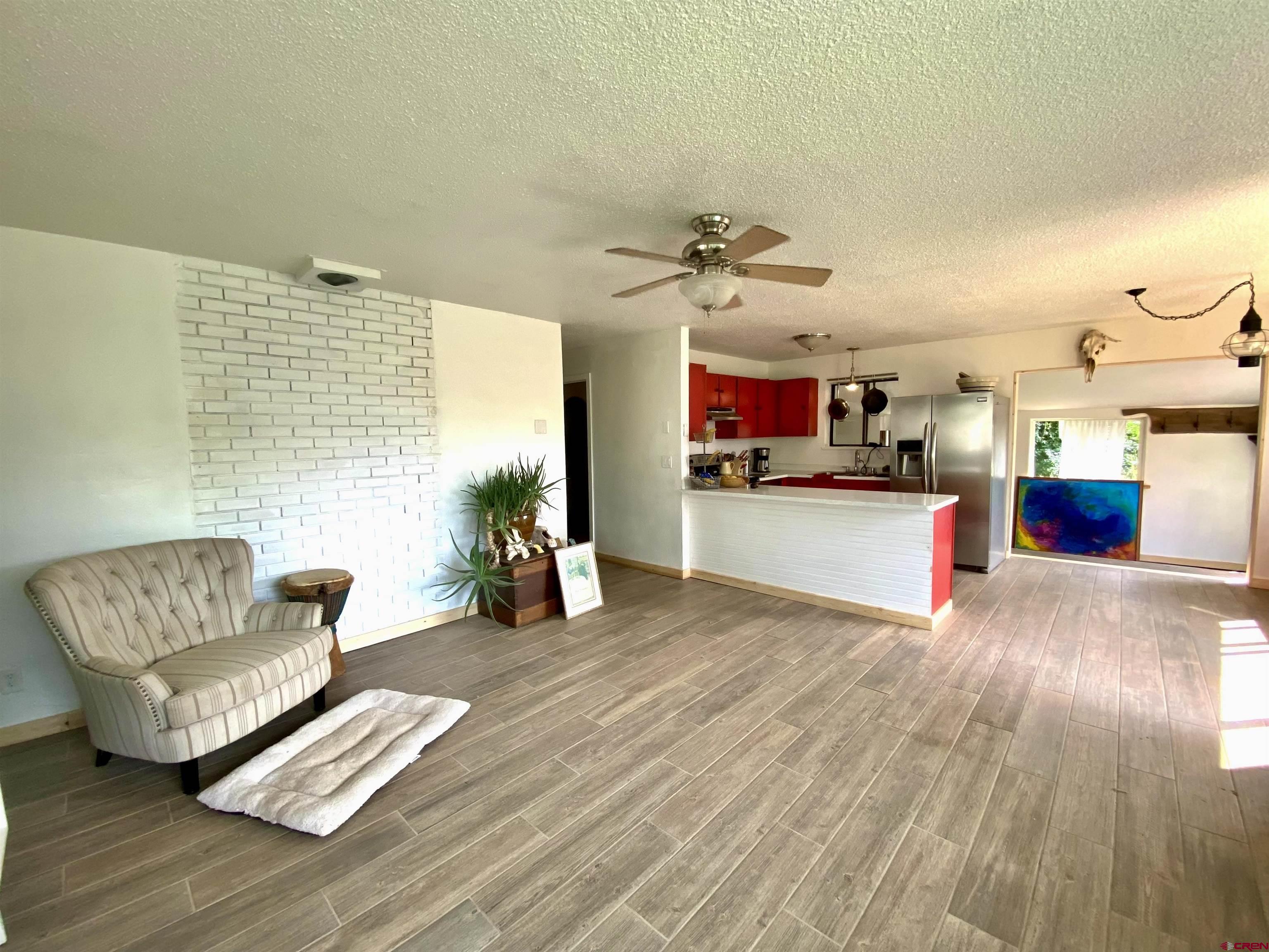 646 Riverside Avenue Mancos, CO 81328 - Photo 4 of 36 a living room with furniture and a wooden floor
