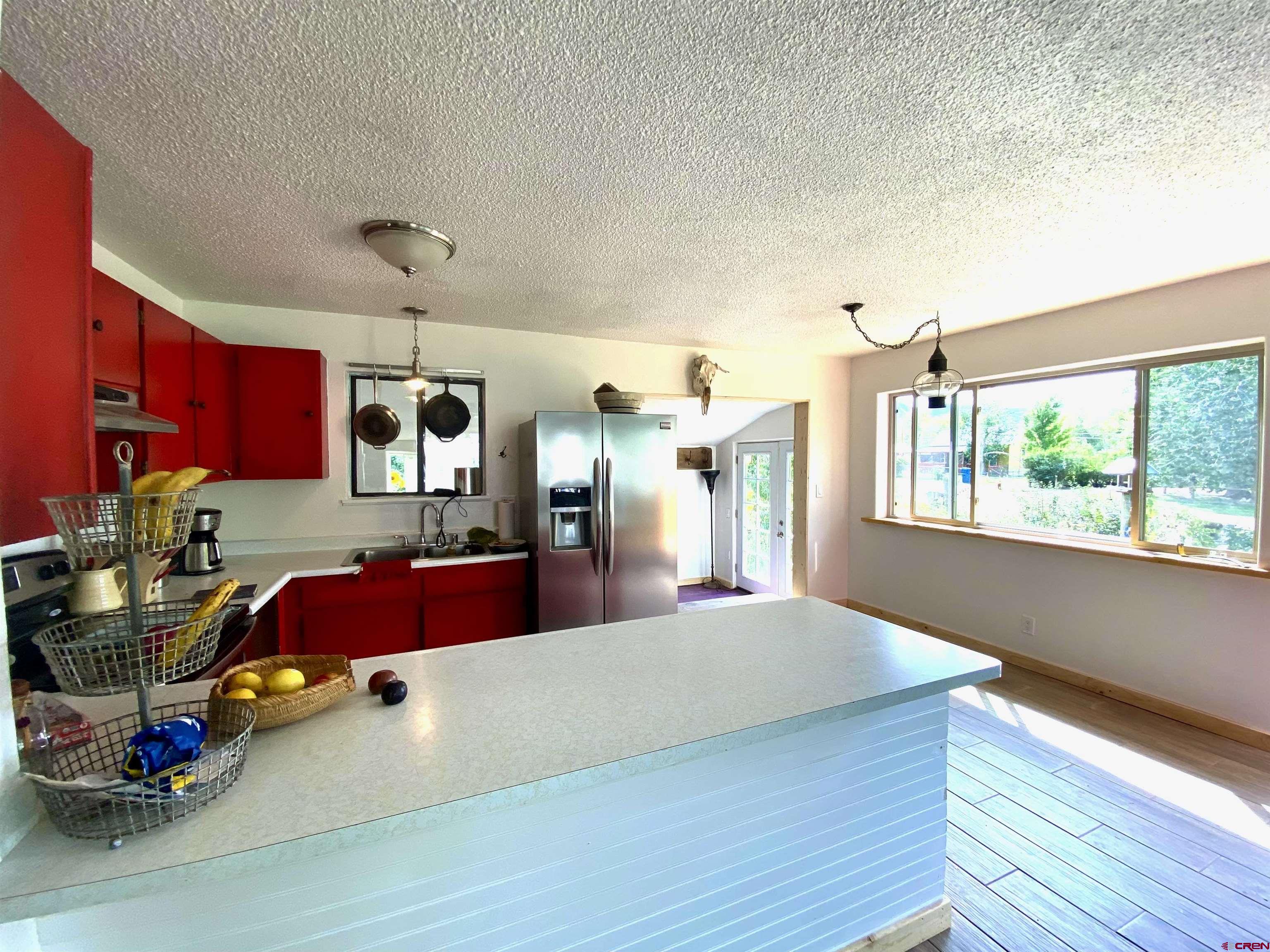 646 Riverside Avenue Mancos, CO 81328 - Photo 5 of 36 a kitchen with furniture and a large window