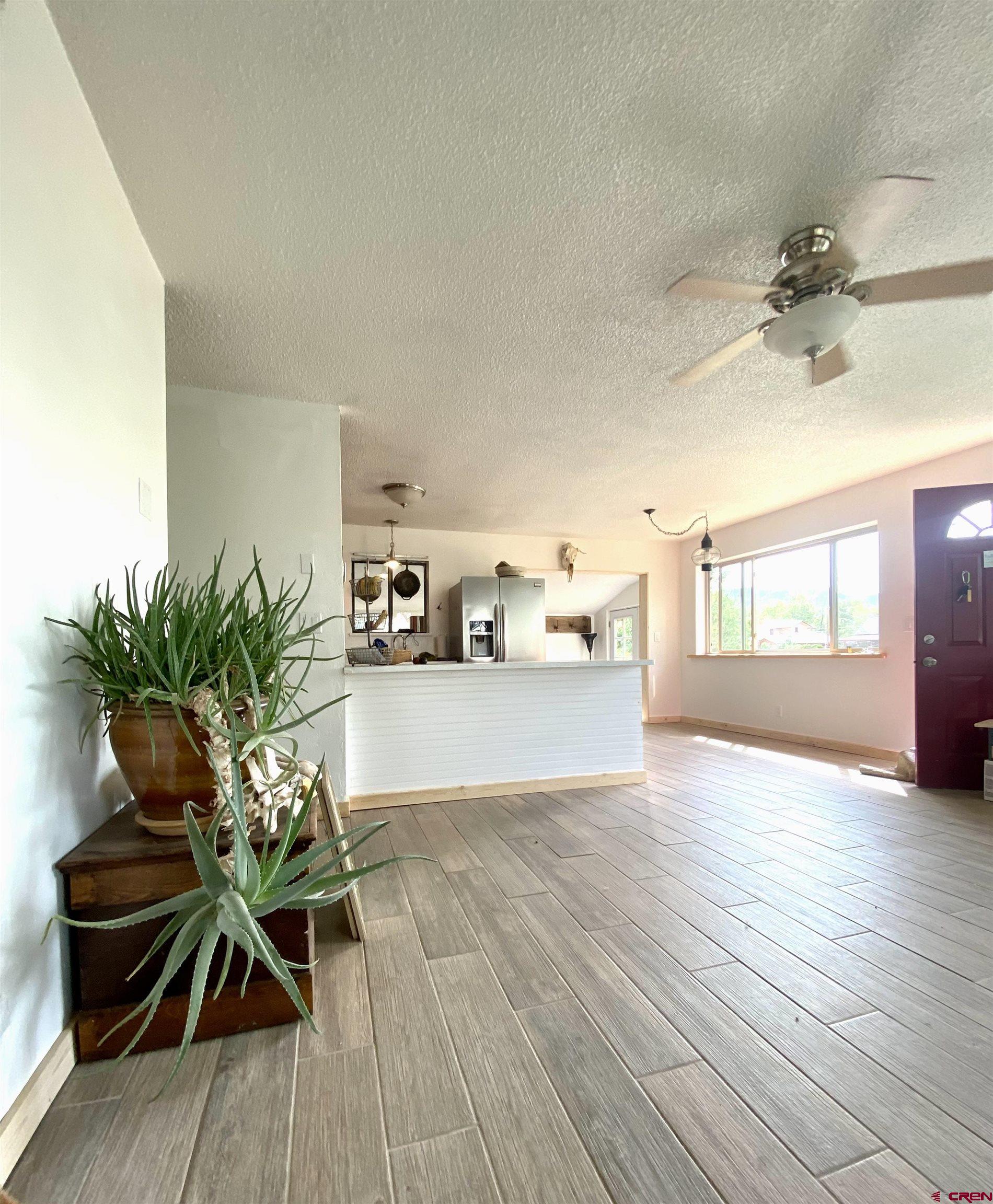 646 Riverside Avenue Mancos, CO 81328 - Photo 6 of 36 a view of a work space with a window and wooden floor