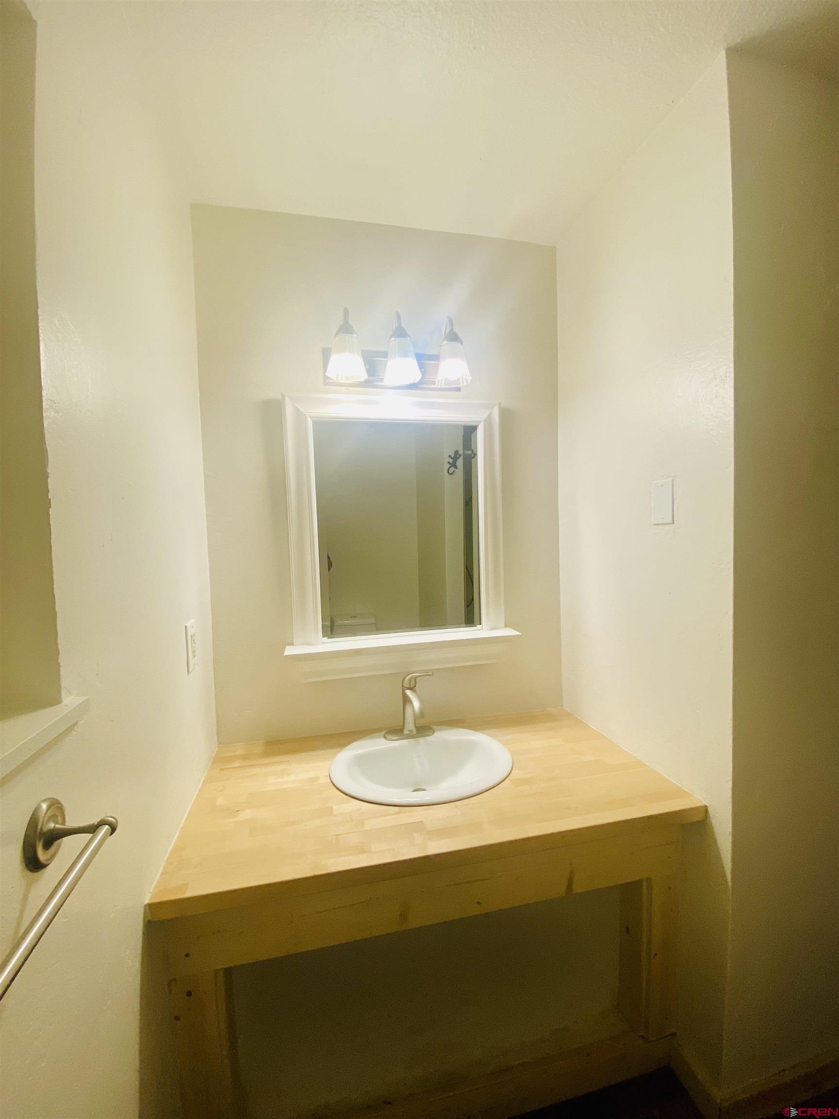 646 Riverside Avenue Mancos, CO 81328 - Photo 9 of 36 a bathroom with a sink and a mirror
