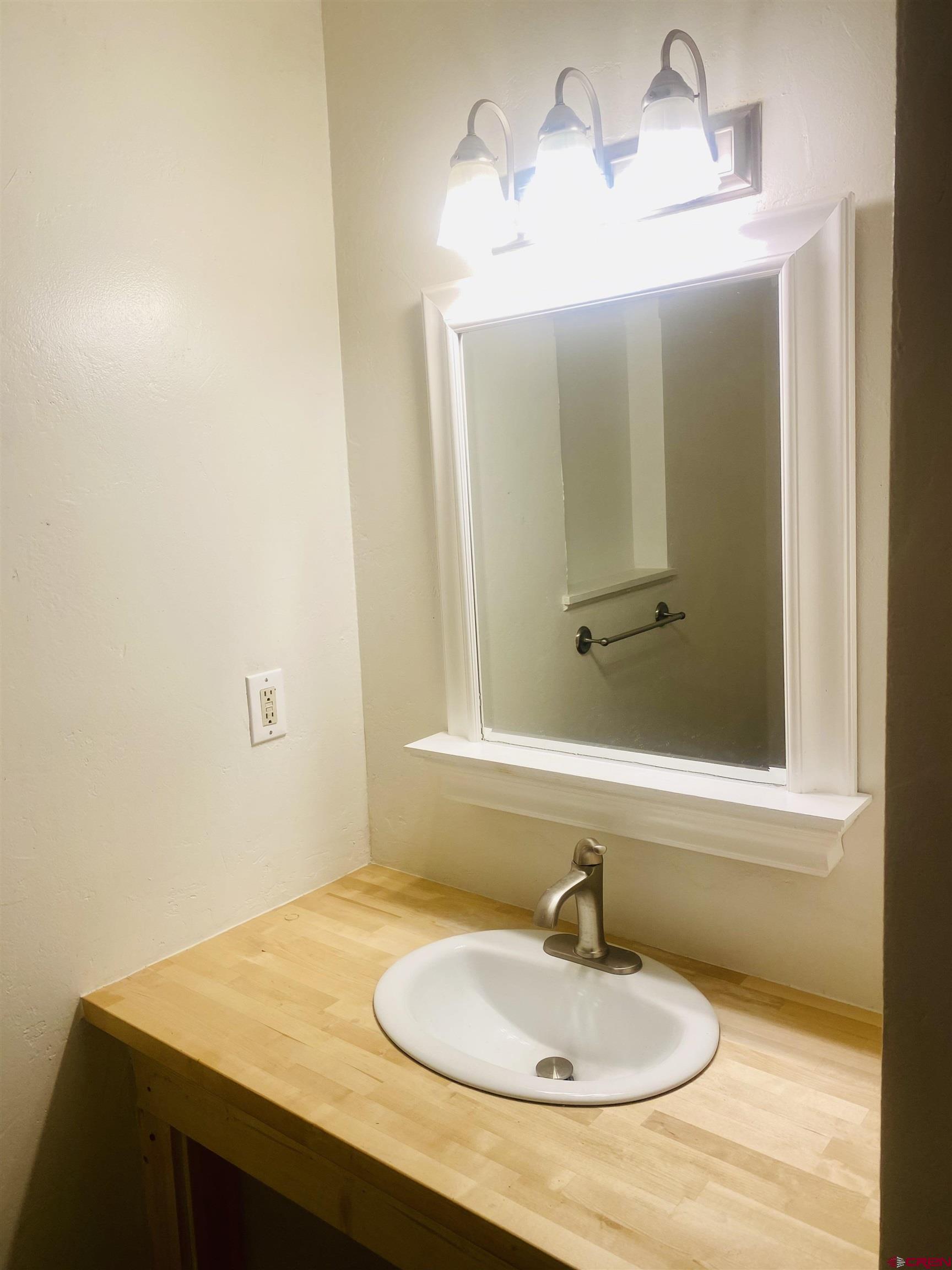 646 Riverside Avenue Mancos, CO 81328 - Photo 10 of 36 a bathroom with a sink and a mirror