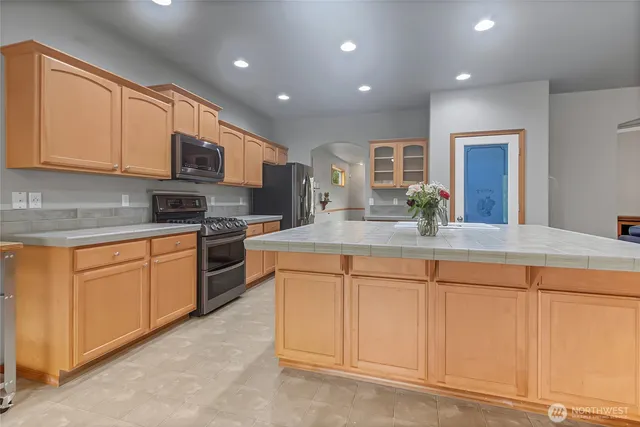 a kitchen with stainless steel appliances granite countertop a sink and cabinets