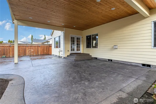 a view of a house with backyard and sitting area