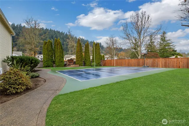 a swimming pool with the garden in the back