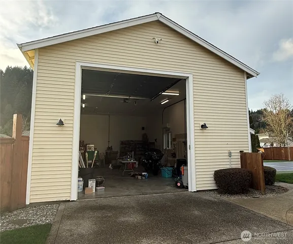 a view of a house with a patio and a yard