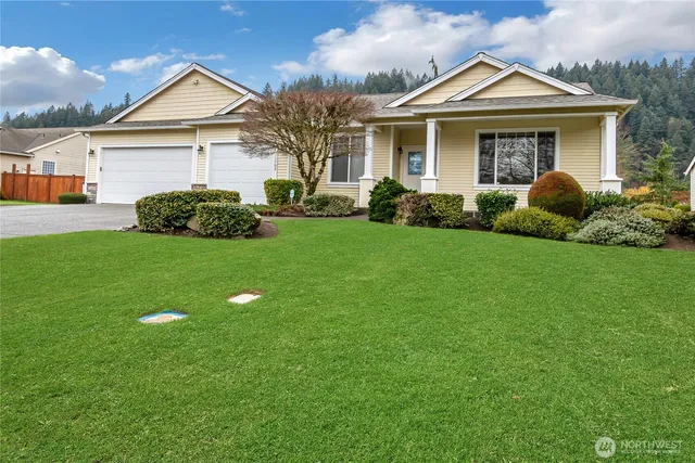 a front view of a house with a yard and garage