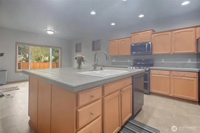 a kitchen with a sink stove and cabinets