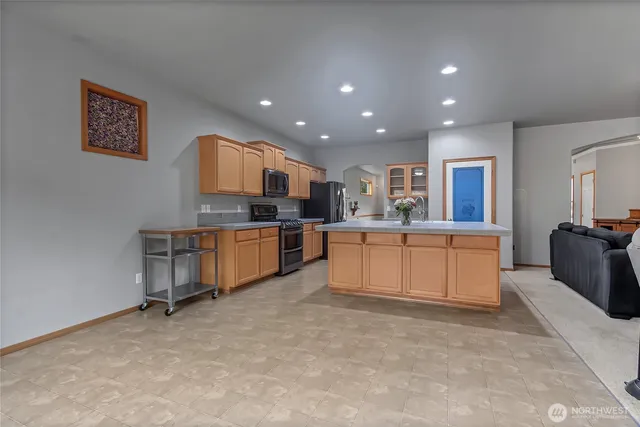a large kitchen with a table and chairs