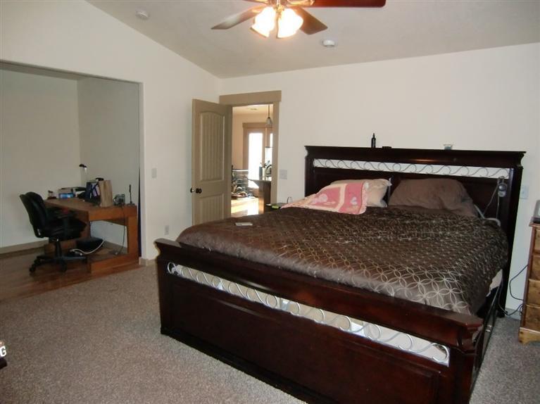 587 Barton Road Eagle Point, OR 97524 - Photo 8 of 13 a bedroom with a bed and a chair in it
