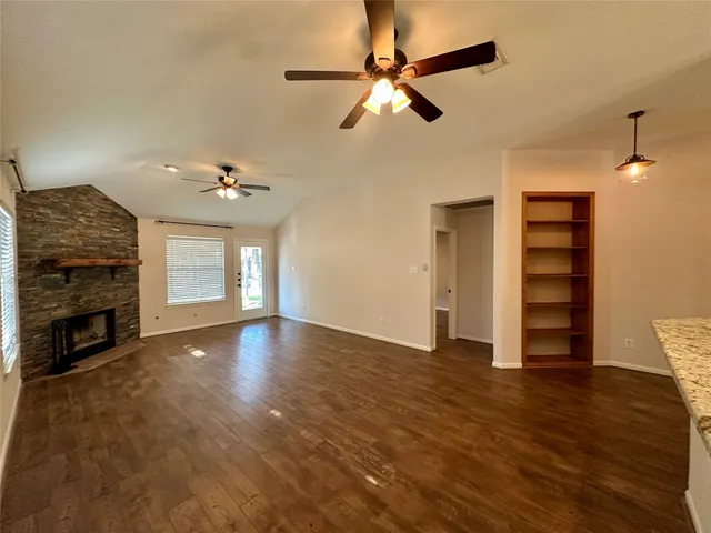 a view of a livingroom with a fireplace a chandelier and stairs