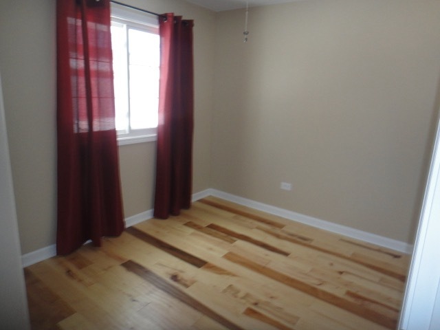 5711 Willow Springs Road Countryside, IL 60525 - Photo 13 of 19 a bedroom with a bed and a window