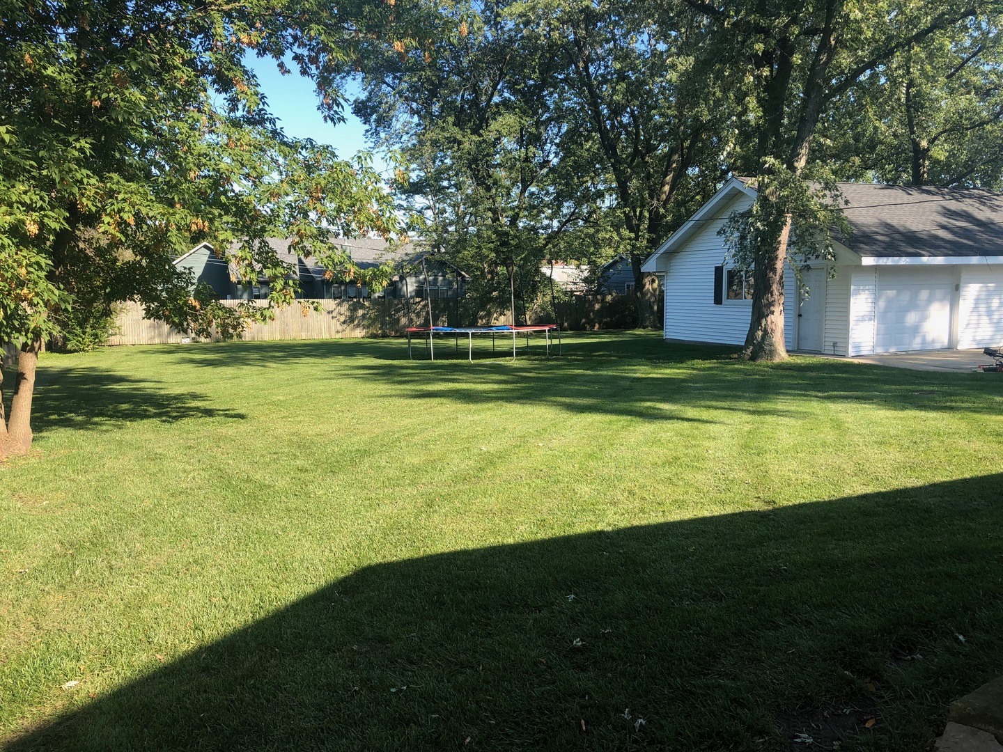 5711 Willow Springs Road Countryside, IL 60525 - Photo 17 of 19 a view of a house with a big yard and a large tree