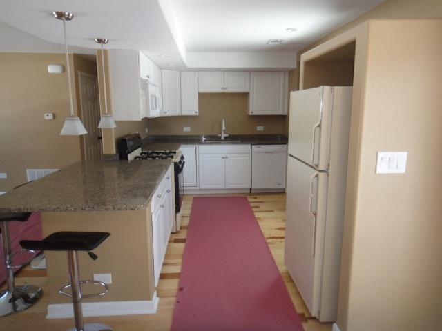 5711 Willow Springs Road Countryside, IL 60525 - Photo 6 of 19 a kitchen with refrigerator and chairs