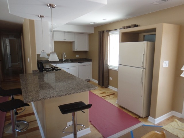 5711 Willow Springs Road Countryside, IL 60525 - Photo 7 of 19 a kitchen with stainless steel appliances granite countertop a refrigerator a stove and a sink