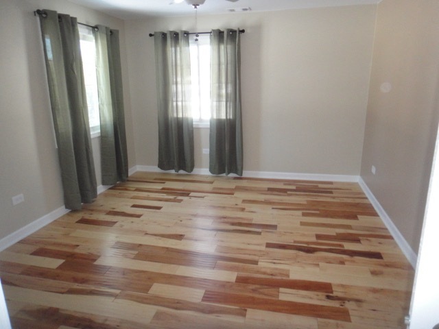 5711 Willow Springs Road Countryside, IL 60525 - Photo 10 of 19 wooden floor and window in an empty room