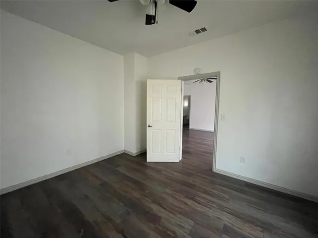 an empty room with wooden floor