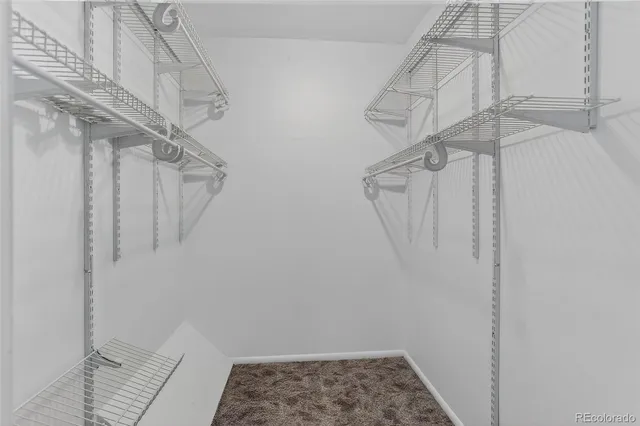 a view of hallway with stairs and wooden floor