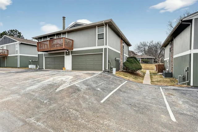 a view of a house with a patio and a yard