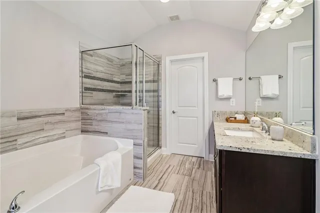 a bathroom with a bathtub a sink and a window