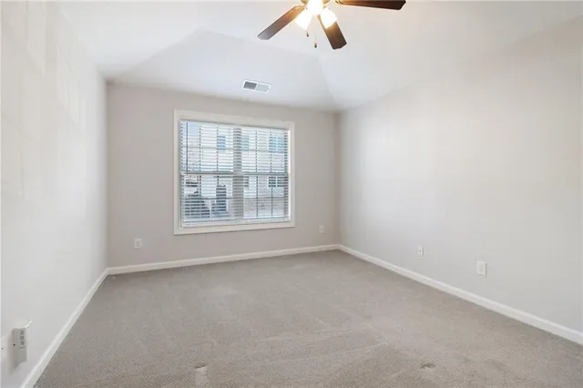 an empty room with a empty space and chandelier fan