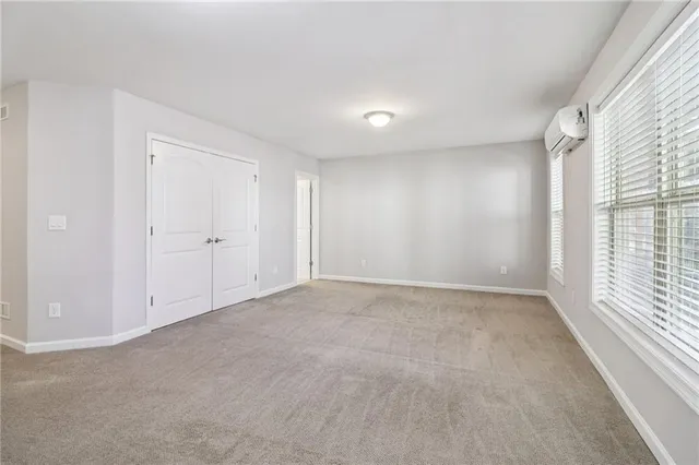 a bathroom with a granite countertop sink toilet a shower and a mirror